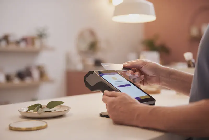 A contactless card payment at an Australian small business with the final price displayed and no readable text